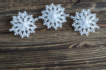 Snowflakes border on wooden background