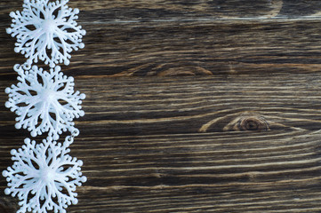Snowflakes border on wooden background