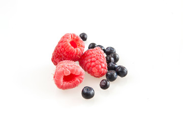 Beautiful raspberry and blueberries isolated on white
