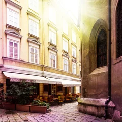 Foto op Plexiglas Old small street with Cafe terrace in small vienna © bellan