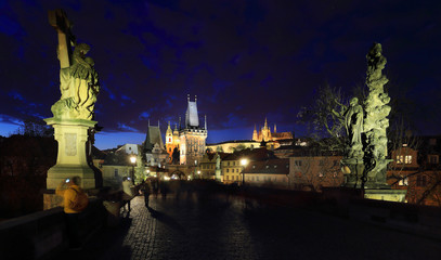 Fototapeta na wymiar Colorful Prague gothic Castle with St. Nicholas' Cathedral from Charles Bridge above the River Vltava in the Night, Czech Republic