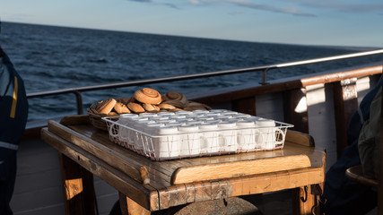 empty cups and Cinnamon roll on tray on boat