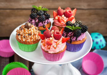 Set of different delicious cupcakes