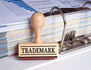 Trademark - rubber stamp with binder in the office