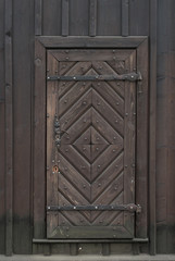 Ancient ,wooden door in wooden wall