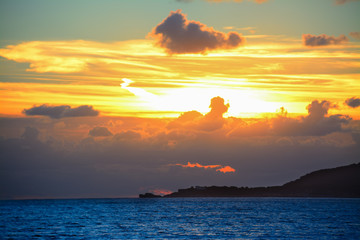 Fototapeta premium blue sea and yellow sky at sunset