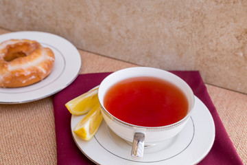 Breakfast with pastries, and hot tea with lemon.