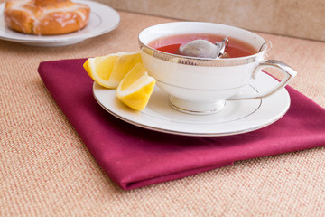 Breakfast with pastries, and hot tea with lemon.