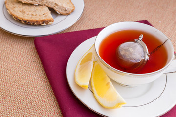 Breakfast with pastries, and hot tea with lemon.