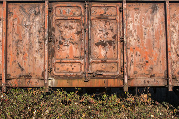 Rusty metal side of old weathered vintage grunge freight wagon as background