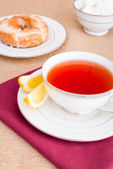 Breakfast with pastries, and hot tea with lemon.