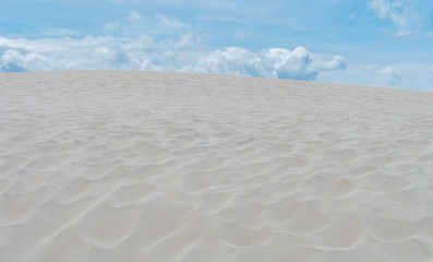Fototapeta na wymiar Sand dune and blue cloudy sku on the Baltic coast in Poland