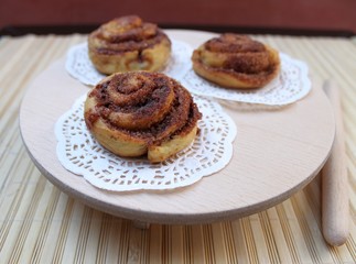 Buns with cinnamon and sugar on a wooden table