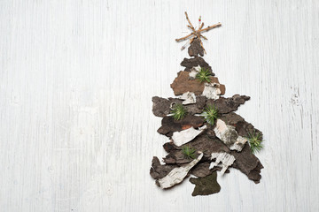 Christmas tree made of tree bark on retro background with space for text
