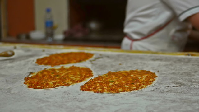 Prepearing Turkish pizza called Lahmacun