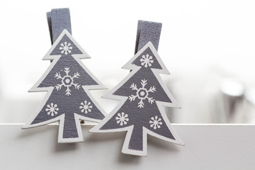 Naklejka na ściany i meble Two christmas tree shaped clothespins, closeup, white background.