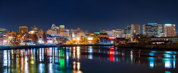 Wilmington skyline panorama reflected in Christiana River. Wilmington, the largest city in the state of Delaware, is built on the site of Fort Christina, the first Swedish settlement in North America - obrazy, fototapety, plakaty