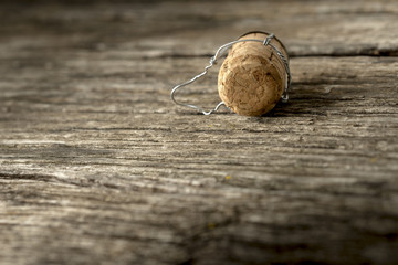 Champagne cork lying on a wooden board