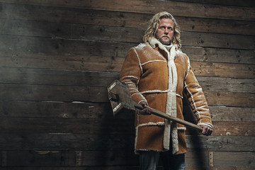 Lumberjack Winter Fashion Man Long Blonde Hair and Beard. Holdin