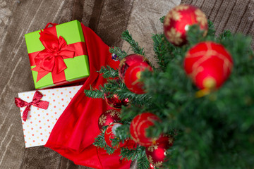 Christmas tree with gift box and decorations on wooden backgroun