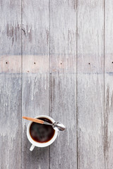cup of coffee and spoon on Wooden Table