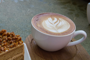Close up cup of Coffee latte on the wood