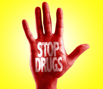 Stop Drugs written on hand with yellow background