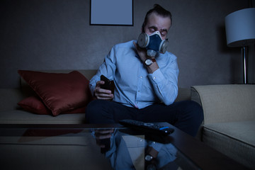 Man in respirator watching TV