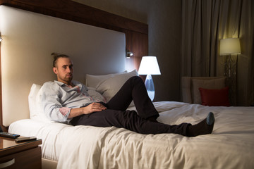 Fototapeta premium Man on the bed