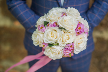 The groom holding the flowers of love