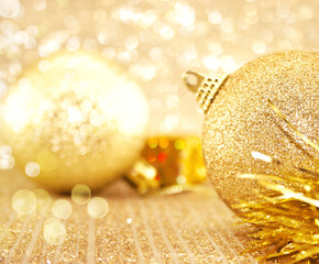 Golden Christmas decorations on shiny background with copy space