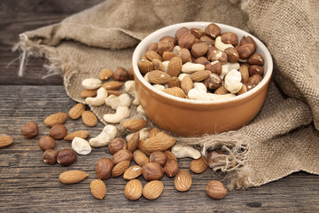 Almonds, cashew and hazelnuts on a rustic wooden board. Healthy