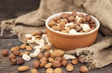 Almonds, cashew and hazelnuts on a rustic wooden board. Healthy