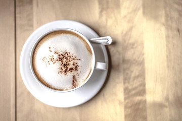 Cup of cappuchino on table. soft focus on the top of coffee