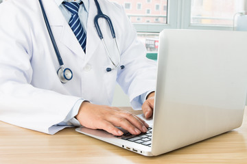Doctors using laptop at work