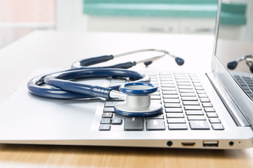 Close up stethoscope and laptop