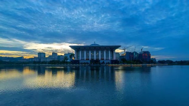 Time lapse 4k Footage of Epic Sunrise At Iron Mosque (Masjid Tuanku Mizan Zainal Abidin), Putrajaya. Showing a moving and changing color clouds. Tilt up