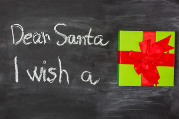 Fototapeta na wymiar Dear Santa is written on a blackboard and christmas gift
