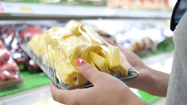 Female Hands with Healthy Fruits in Supermarket 