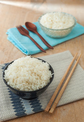White rice in bowl with wooden chopsticks