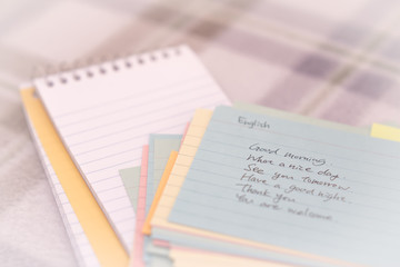 English; Learning New Language Writing Greetings on the Notebook