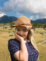 Fashion portrait of young beautiful woman posing in nature