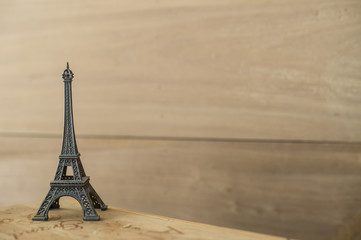 Toys Eiffel Tower on the background of wood.