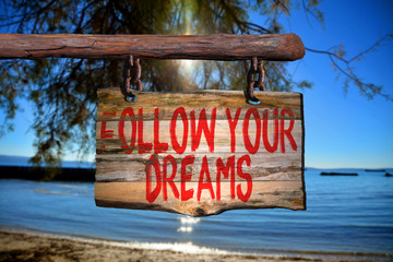 Fototapeta premium Follow your dreams motivational phrase sign