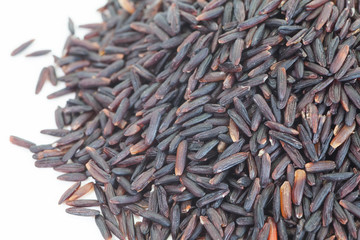 Uncooked brown rice on a white background