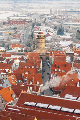 Winter panorama of medieval town within fortified wall. Top view from 