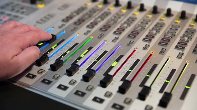 Sound producer Working On A Audio Mixing Console, Sound Mixer, Volume Turns Up