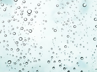 Water rain drop on window glass with white blue sky  cloudy back