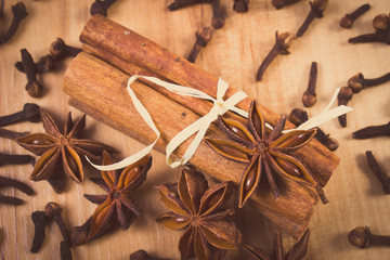 Vintage photo, Star anise, cinnamon sticks and cloves on wooden table, seasoning for cooking