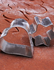Metal cookie cutters and dough for gingerbread